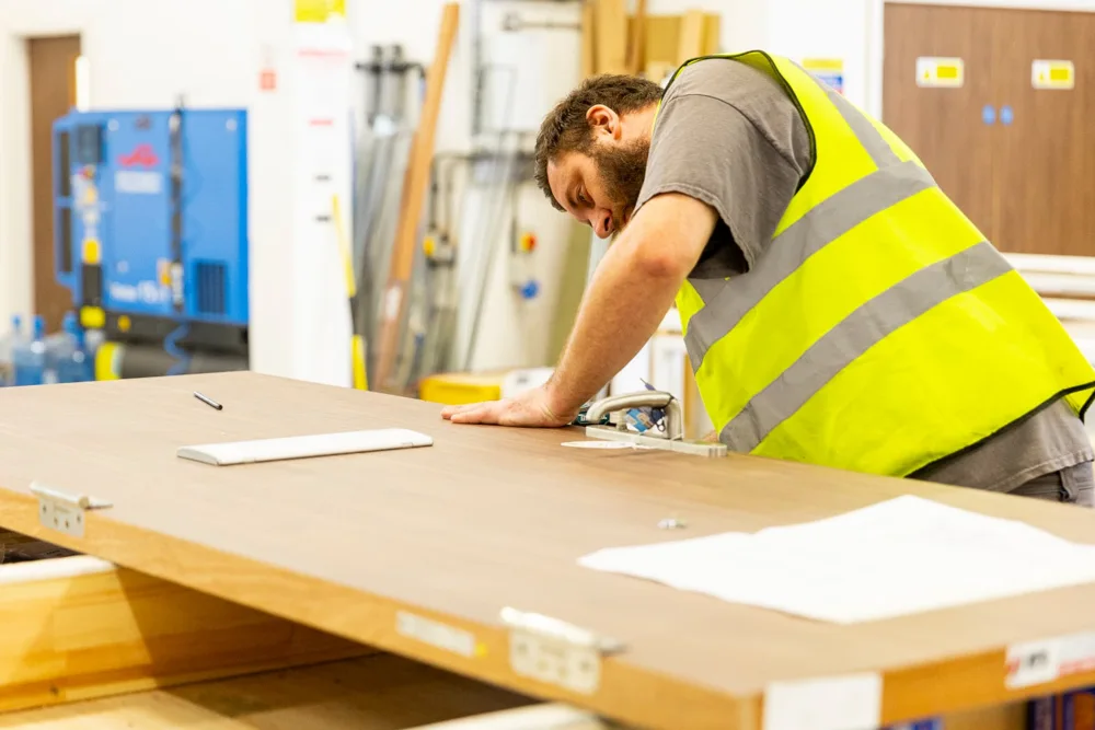 EFS team member inspecting the surface of a finished timber fire door