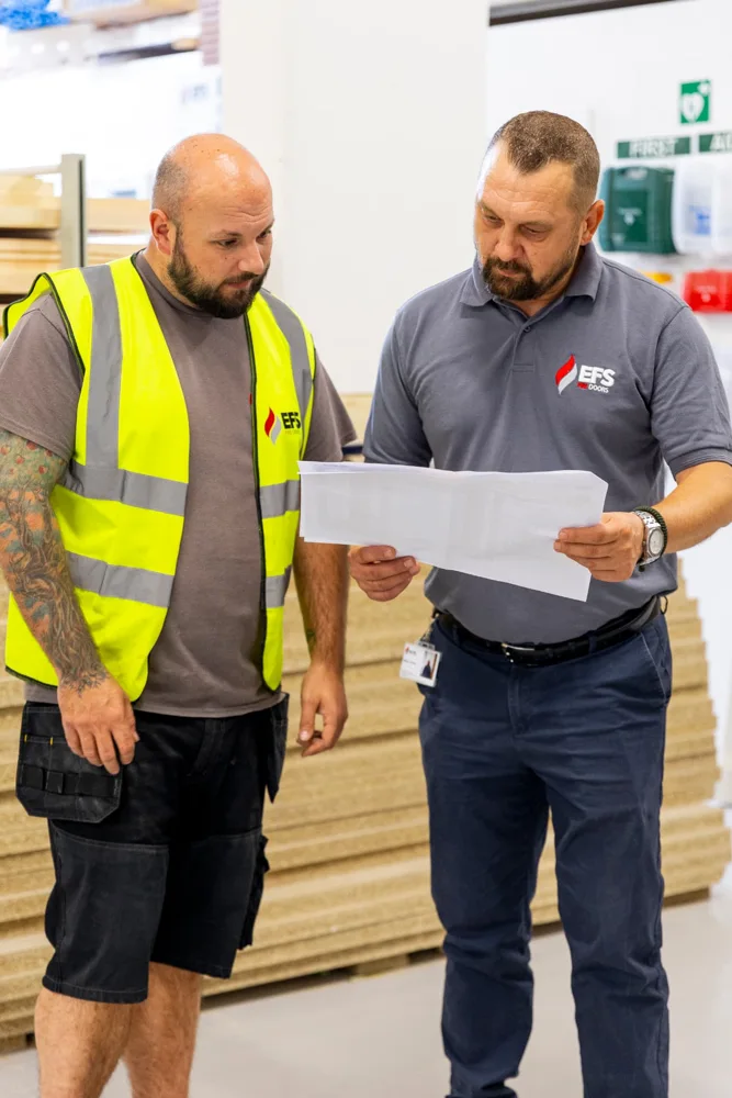 Two EFS team members reviewing manufacturing specifications together